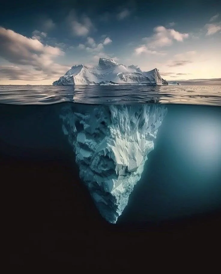 A solitary iceberg above and below the ocean surface